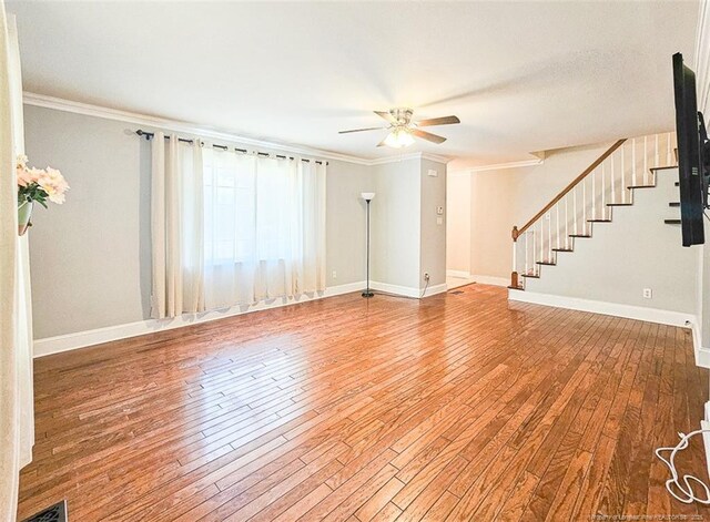 1003 Anarine Rd, Fayetteville, NC 28303 - unfurnished living room with a ceiling fan, hardwood / wood-style floors, stairway, ornamental molding, and baseboards