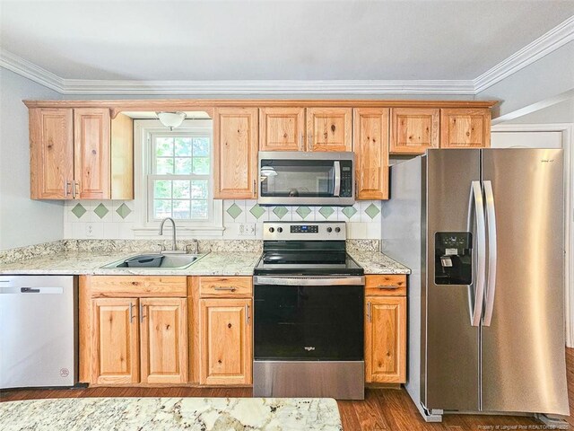 1003 Anarine Rd, Fayetteville, NC 28303 - kitchen with stainless steel appliances, a sink, ornamental molding, light stone counters, and wood finished floors