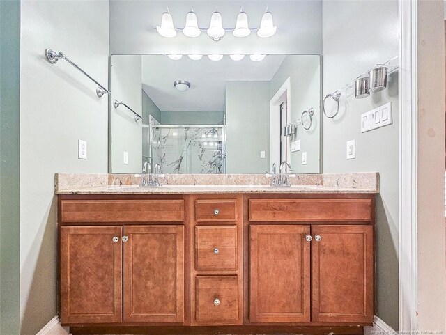 1003 Anarine Rd, Fayetteville, NC 28303 - full bath featuring a shower stall, baseboards, and double vanity