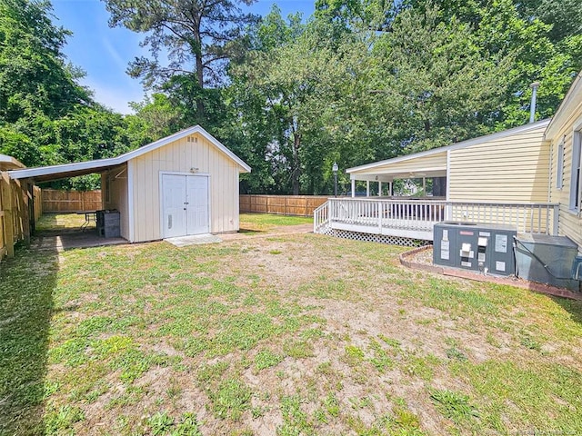 1003 Anarine Rd, Fayetteville, NC 28303 - view of yard featuring a wooden deck, an outbuilding, and a storage unit