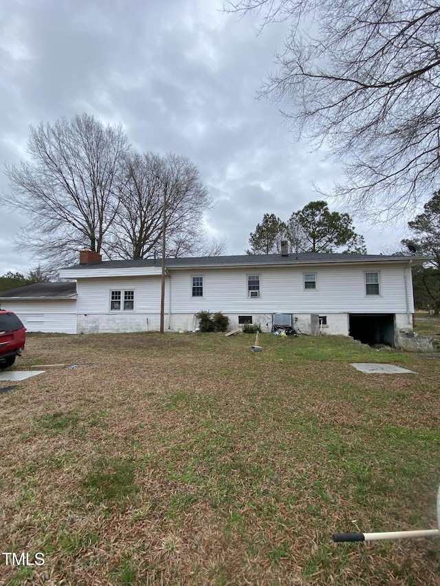 rear view of house with a lawn