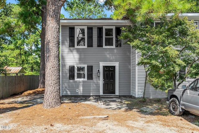 view of front of home featuring fence