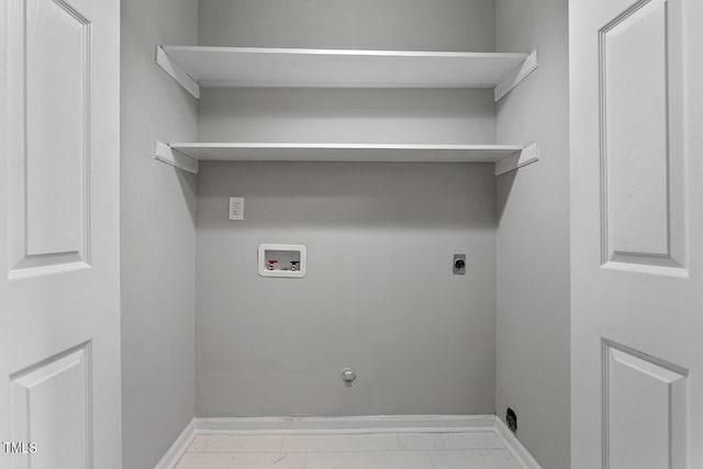 clothes washing area featuring hookup for a washing machine, hookup for a gas dryer, hookup for an electric dryer, and baseboards