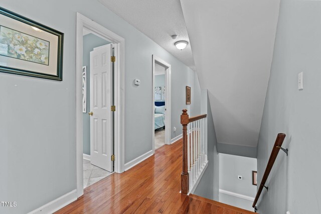 6509 Virgilia Ct, Raleigh, NC 27616 - hall featuring baseboards, light wood-style flooring, and an upstairs landing