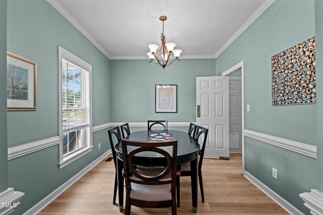 6509 Virgilia Ct, Raleigh, NC 27616 - dining space featuring an inviting chandelier, ornamental molding, and light wood finished floors