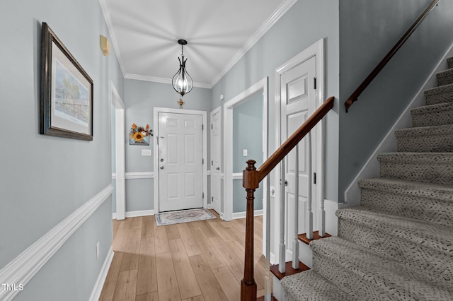 6509 Virgilia Ct, Raleigh, NC 27616 - entryway featuring stairway, baseboards, crown molding, and light wood-style flooring