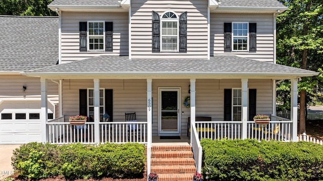 6509 Virgilia Ct, Raleigh, NC 27616 - farmhouse with covered porch, a shingled roof, an attached garage, and driveway