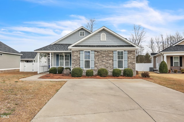 craftsman inspired home with cooling unit, fence, a front yard, and a gate