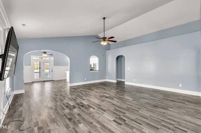 unfurnished living room with arched walkways, visible vents, ceiling fan, and dark wood-style flooring