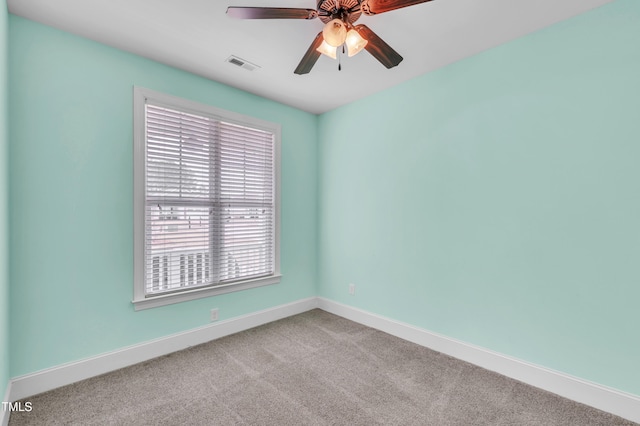 spare room with visible vents, baseboards, ceiling fan, and carpet flooring