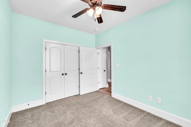 unfurnished bedroom featuring a closet, baseboards, and carpet flooring