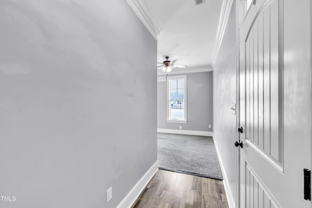 interior space with wood finished floors, baseboards, and ornamental molding