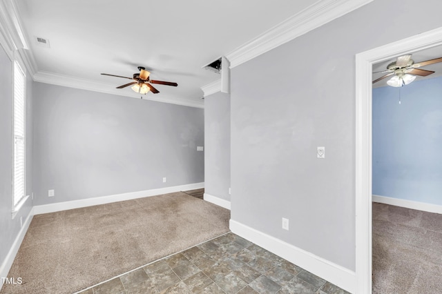 carpeted spare room featuring plenty of natural light, visible vents, and ornamental molding