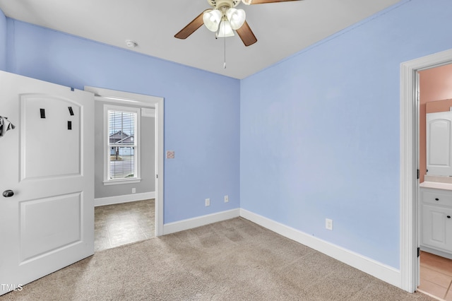 unfurnished bedroom featuring baseboards, light colored carpet, and ceiling fan