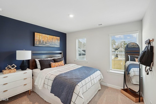 bedroom featuring carpet floors, multiple windows, and baseboards