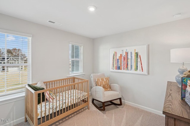 carpeted bedroom featuring multiple windows, visible vents, and baseboards