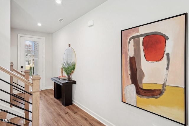 hallway featuring recessed lighting, visible vents, stairway, light wood-style floors, and baseboards