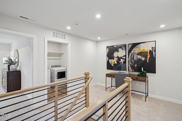 interior space featuring washing machine and clothes dryer, visible vents, and recessed lighting