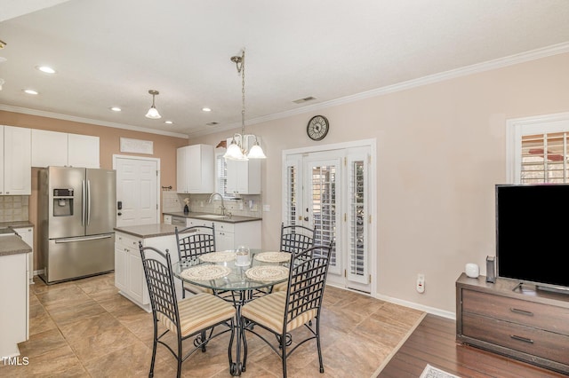 dining space with ornamental molding, recessed lighting, and baseboards