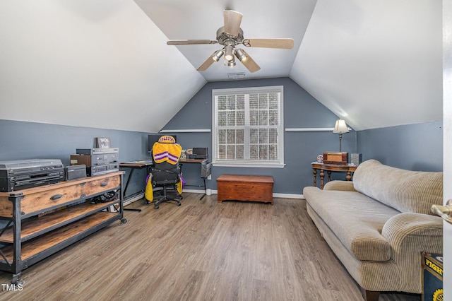 home office featuring visible vents, baseboards, ceiling fan, wood finished floors, and vaulted ceiling