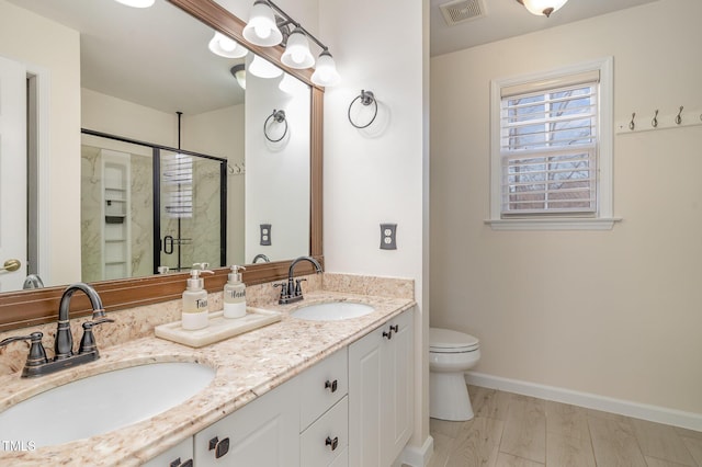 full bath with visible vents, a sink, a shower stall, and toilet