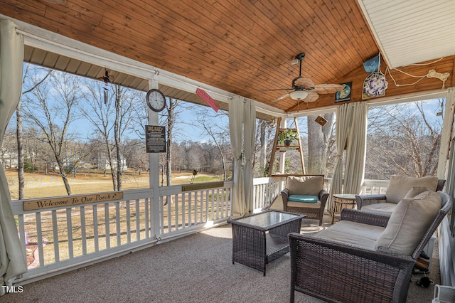 sunroom featuring a ceiling fan, lofted ceiling, and wood ceiling