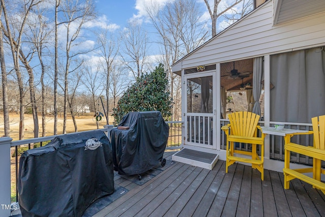 deck featuring a sunroom and area for grilling