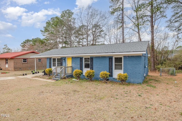 ranch-style home with roof with shingles and brick siding