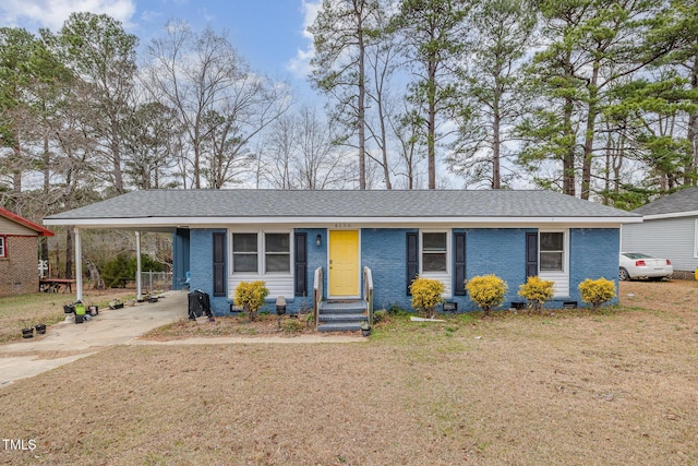 single story home featuring driveway, crawl space, a front lawn, a carport, and brick siding