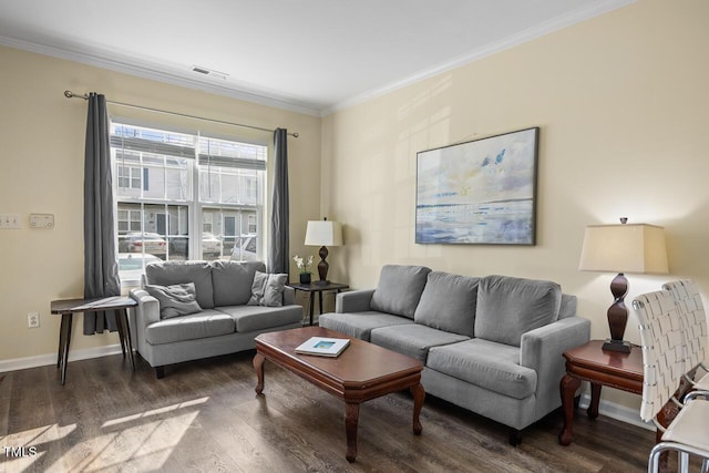 living area with visible vents, crown molding, baseboards, and wood finished floors