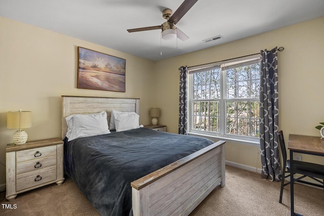 bedroom with carpet floors, baseboards, visible vents, and a ceiling fan