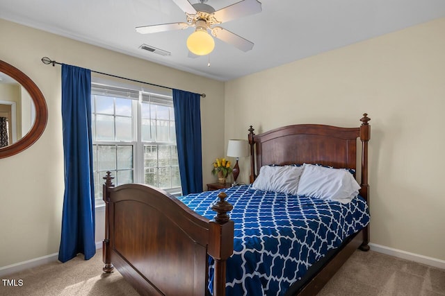 carpeted bedroom with ceiling fan, visible vents, and baseboards