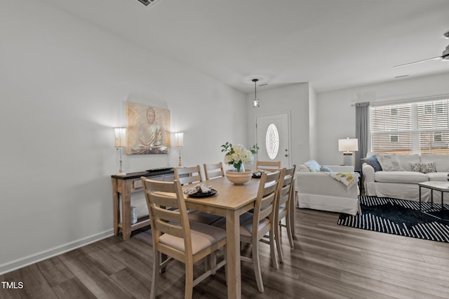 dining area with baseboards, a ceiling fan, and wood finished floors