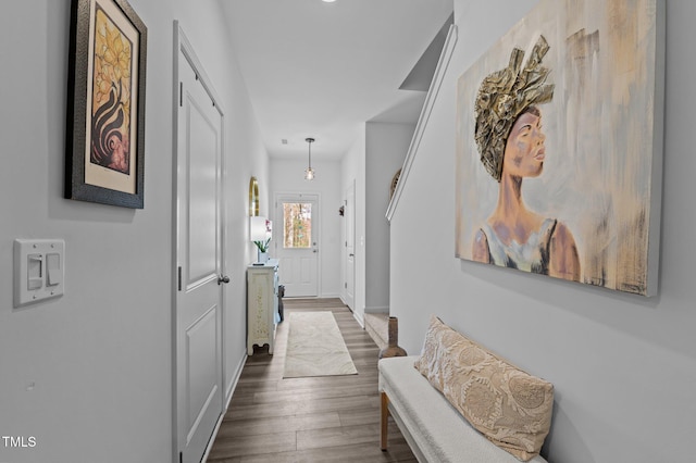 hallway with baseboards and dark wood-type flooring