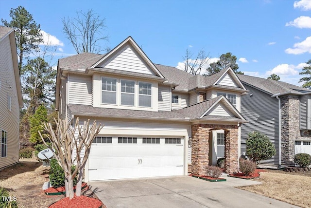 view of front of property with driveway, stone siding, an attached garage, and roof with shingles