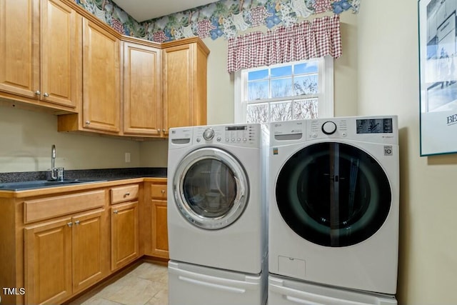 laundry room with separate washer and dryer, light tile patterned flooring, a sink, and cabinet space