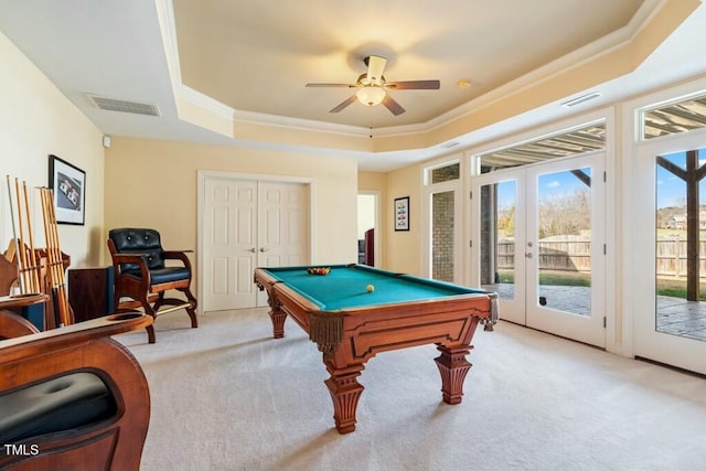 rec room featuring a raised ceiling, visible vents, light carpet, and french doors