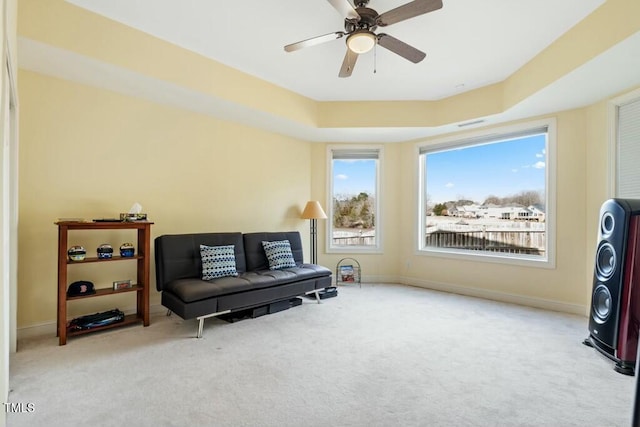 sitting room featuring carpet floors, a ceiling fan, and baseboards