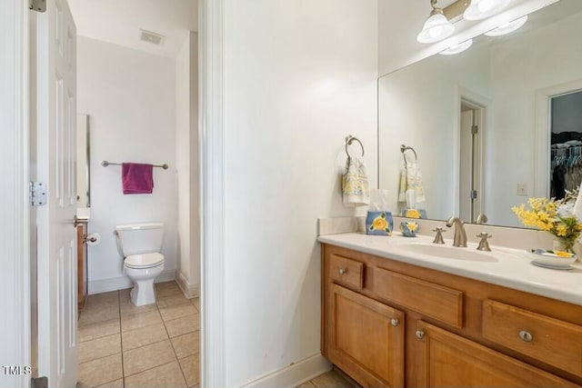 bathroom with visible vents, baseboards, toilet, tile patterned flooring, and vanity