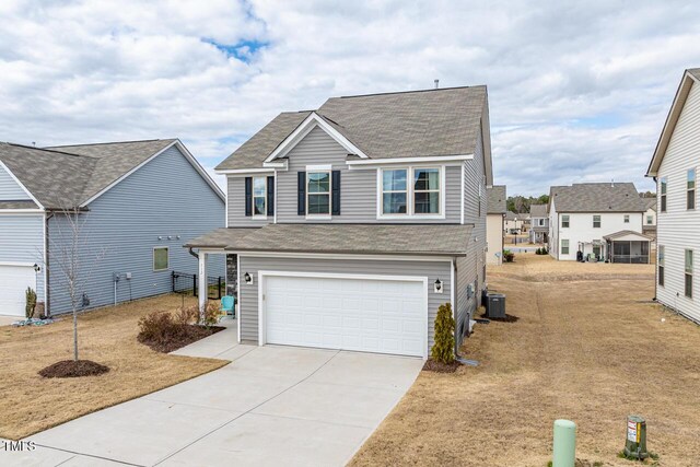 traditional home with driveway, an attached garage, a shingled roof, and cooling unit