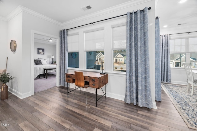 interior space with ornamental molding, visible vents, baseboards, and wood finished floors