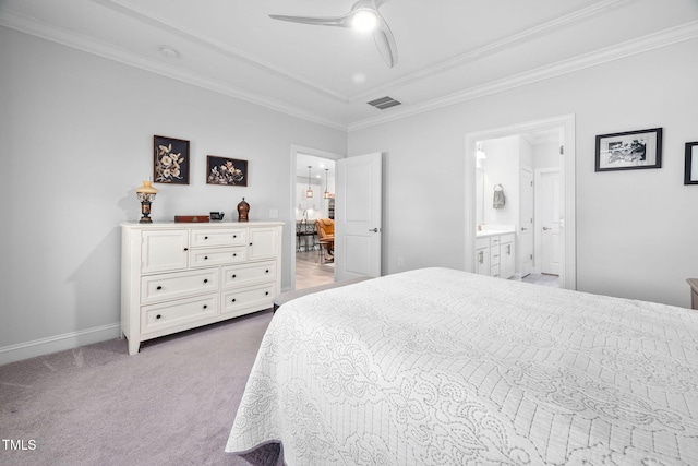 carpeted bedroom with baseboards, visible vents, ceiling fan, ornamental molding, and ensuite bathroom