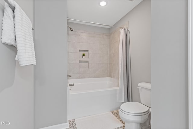 full bathroom featuring toilet and shower / bathtub combination with curtain