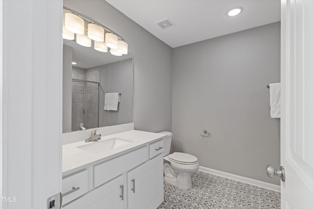 bathroom with a stall shower, baseboards, visible vents, toilet, and vanity