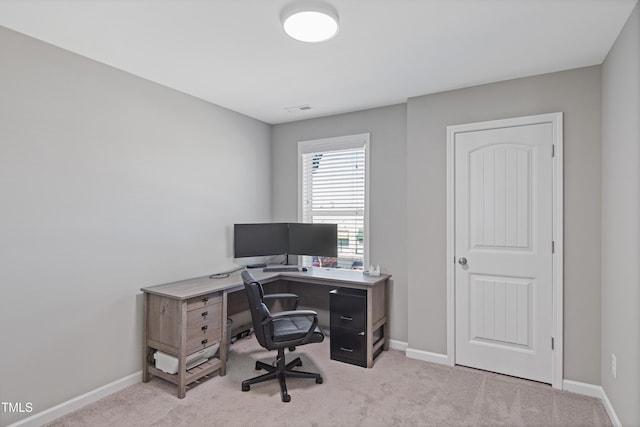 office space with light colored carpet, visible vents, and baseboards