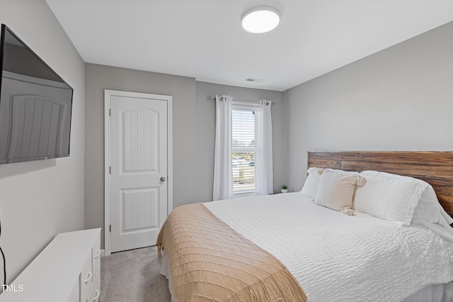 bedroom with visible vents and light colored carpet