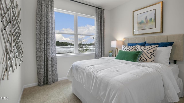 bedroom featuring carpet and baseboards