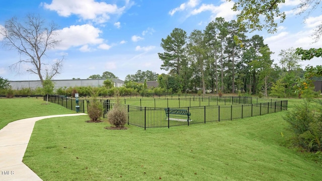 view of home's community featuring fence and a lawn