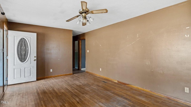 entryway featuring ceiling fan, wood finished floors, and baseboards