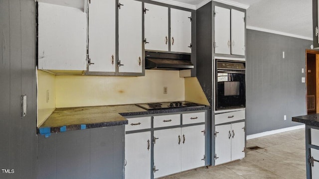 kitchen with dark countertops, ornamental molding, white cabinetry, under cabinet range hood, and black appliances